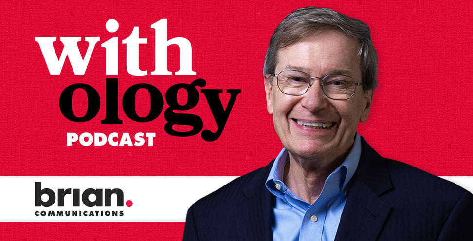 Brian Communication's EVP,  Ed Mahlman smiles in front of a red background. Behind him the text reads " Withology podcast". 