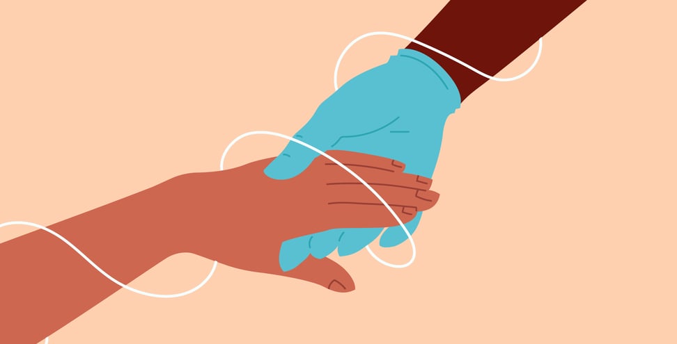 On a light pink background is a hand in a blue medical glove holding another hand. The hands are encompassed by a thin white spiral. 