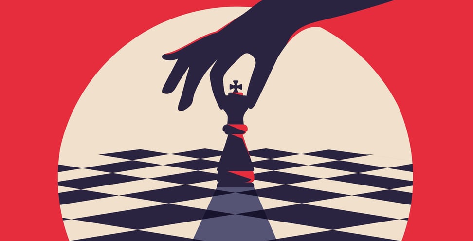 An illustration of a hand placing the king piece on a chess board. 