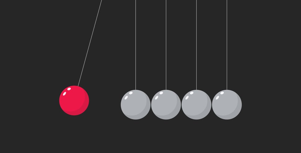 Red sphere hanging on threads hitting another pendulum group