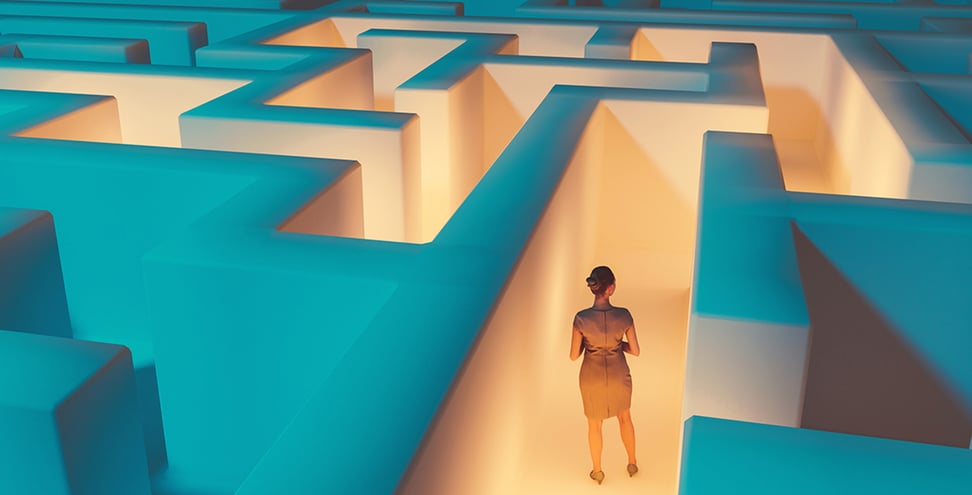 Woman stands in the middle of dark maze. Lights guide the way for her. Concept of standing in front of a challenge and finding the right solution to move on.