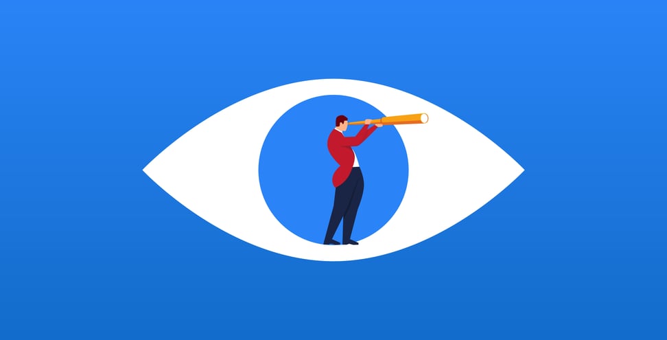Businessman holding a telescope standing inside the eyes looking into the distance