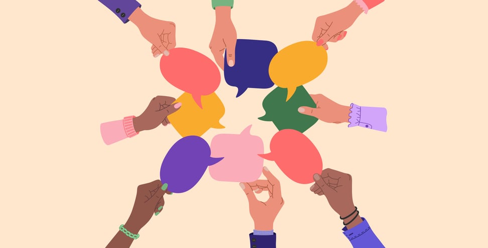 Diverse human hands holding speech bubbles.