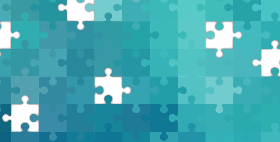 A teal-colored puzzle with several missing pieces.